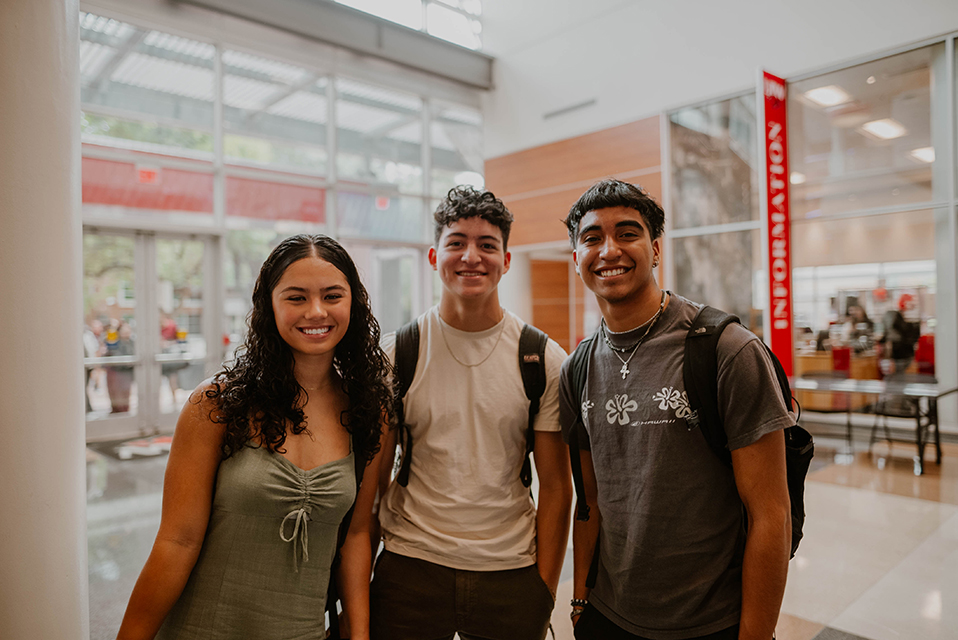 Three UIW students posing together in the Student Engagement Center building