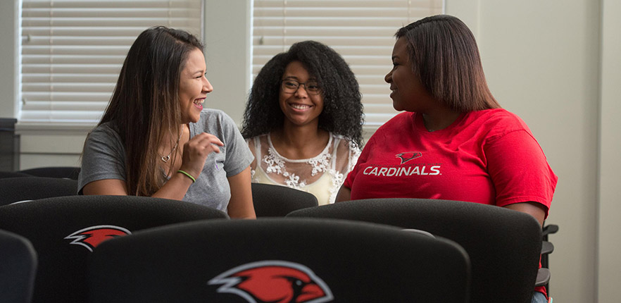 Photo of three students chatting