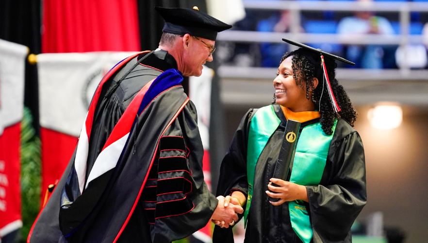 Graduate shaking Dr. Evans' hand