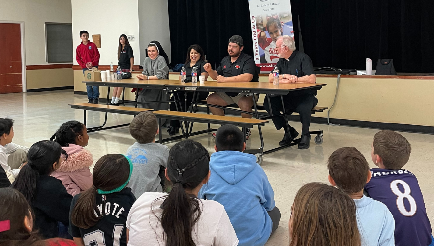Panelists speaking with students