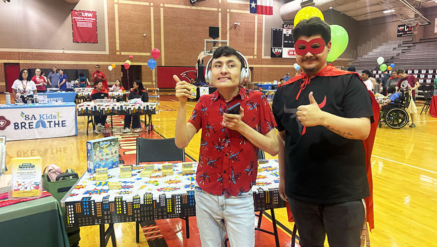 Child and student smiling at booth