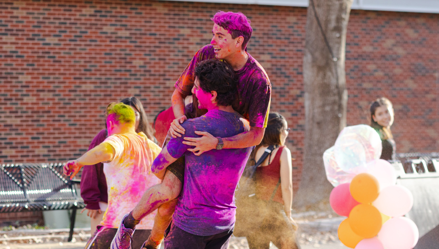 Students at Holi color throw