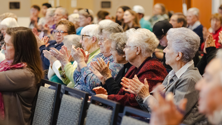 Audience members clapping